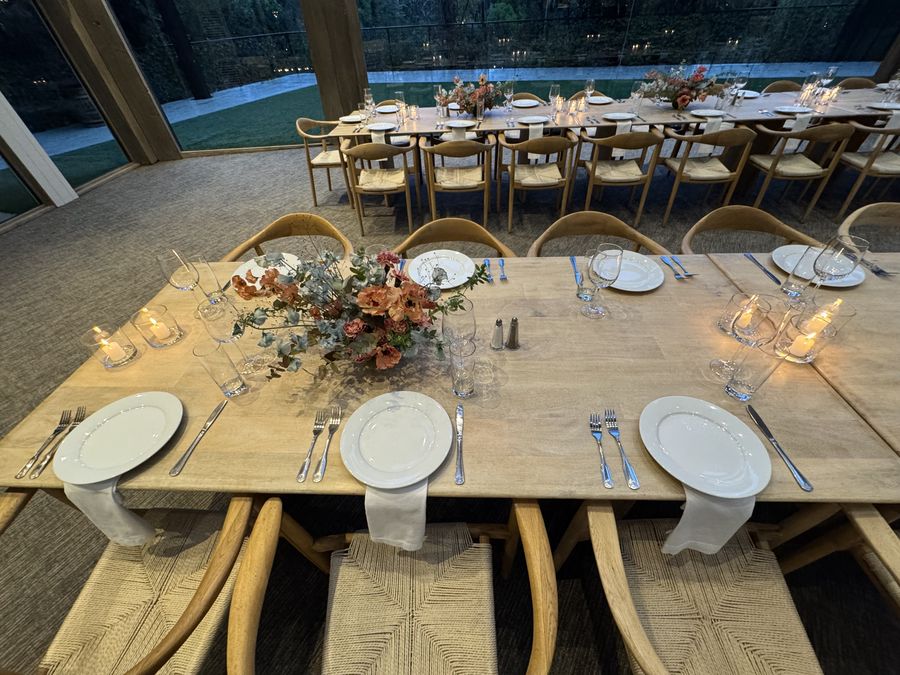Place settings with a floral centerpiece and candles