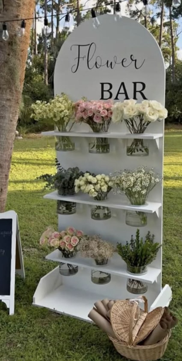 Inspiration: a white arched flower bar with vases on shelves