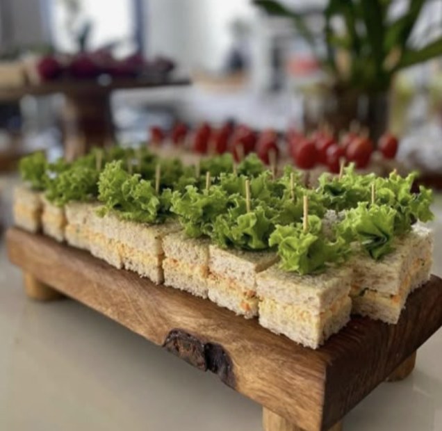 Inspiration: tea sandwiches topped with lettuce on a wood board