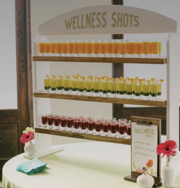 Inspiration: a wellness shots bar with layered juice shots on a wooden shelf