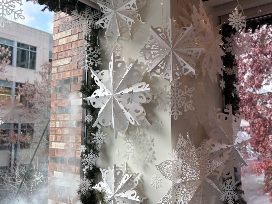 Paper snowflakes and garland styled in a window corner